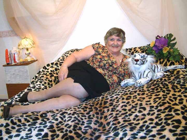 Fat granny naked on a tiger-skin blanket